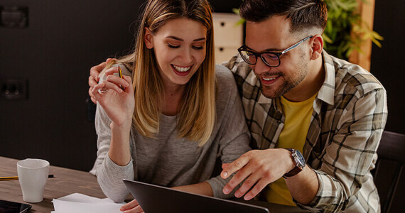 A couple sit at their computer working through their tax return