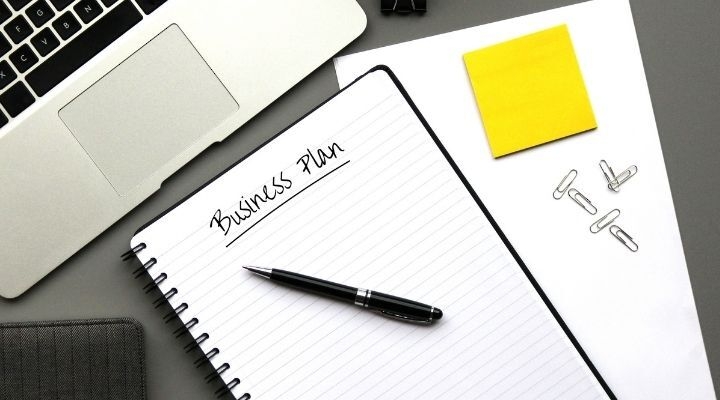 pen on notebook reading Business Plan