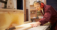 Female Apprentice Using Circular Saw In Carpentry Workshop