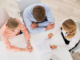 group of people looking at documents on table